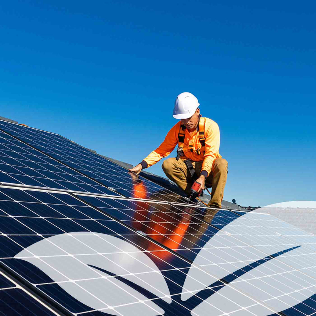 Man installing solar panels on roof