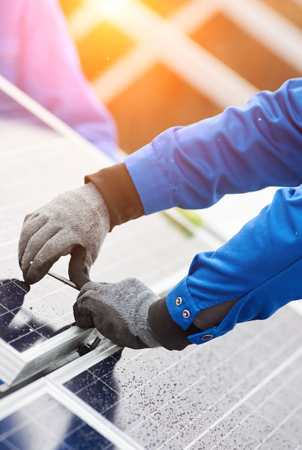 Closeup of hands maintaining solar panels